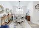 Light-filled dining area with modern decor, white shutters, and a stylish chandelier at 452 Lime Ave, Daytona Beach, FL 32124