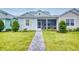 Charming single-story home with a well-manicured lawn and inviting walkway to the screened porch at 452 Lime Ave, Daytona Beach, FL 32124
