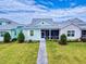 Charming single-story home with a well-manicured lawn and inviting walkway to the screened porch at 452 Lime Ave, Daytona Beach, FL 32124