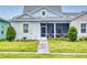 Charming single-story home with a well-manicured lawn and inviting walkway to the screened porch at 452 Lime Ave, Daytona Beach, FL 32124