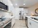 Modern kitchen with stainless steel appliances, quartz countertop, and bright recessed lighting at 452 Lime Ave, Daytona Beach, FL 32124