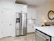 Modern kitchen design featuring stainless steel appliances, white cabinetry and hardwood floors at 452 Lime Ave, Daytona Beach, FL 32124