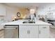 A view of the island with quartz countertop and stainless steel dishwasher in the kitchen at 452 Lime Ave, Daytona Beach, FL 32124