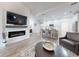 Open concept living area with fireplace, leading to the kitchen with breakfast bar seating at 452 Lime Ave, Daytona Beach, FL 32124