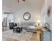 Bright living room featuring vaulted ceilings, a cozy gray sofa, and a stylish area rug at 452 Lime Ave, Daytona Beach, FL 32124