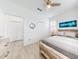 This is a bedroom with white walls, wood-look flooring, a ceiling fan, shuttered windows and closet at 456 Lime Ave, Daytona Beach, FL 32124