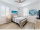 Bright bedroom with a ceiling fan, shuttered windows, wood-look floors, and beach-themed decor at 456 Lime Ave, Daytona Beach, FL 32124