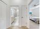 Bright hallway featuring a bathroom and bedroom, with fresh white paint and modern wood-look flooring at 456 Lime Ave, Daytona Beach, FL 32124