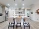 Well-lit kitchen with stainless steel appliances, a large island with bar seating, and modern pendant lights at 456 Lime Ave, Daytona Beach, FL 32124