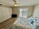 Comfortable bedroom featuring a ceiling fan, large closet, and sliding doors to the balcony at 501 N Causeway # 2050, New Smyrna Beach, FL 32169