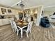 Open-concept dining area connected to a modern kitchen, complete with white cabinetry and granite countertops at 501 N Causeway # 2050, New Smyrna Beach, FL 32169