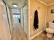 Hallway and partial bathroom view showcases closet space and bedroom with balcony overlooking water at 501 N Causeway # 2050, New Smyrna Beach, FL 32169