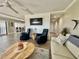 Cozy living room featuring comfortable seating, wood-look flooring, and a mounted art piece at 501 N Causeway # 2050, New Smyrna Beach, FL 32169