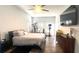Spacious main bedroom featuring a ceiling fan, exercise equipment, and a wall-mounted television at 510 Sun Lake Dr, Port Orange, FL 32127