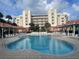 Resort-style pool with lounge chairs and building view at 5300 S Atlantic Ave # 7-502, New Smyrna Beach, FL 32169