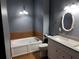 Bathroom displays a white bathtub, toilet, vanity, and tile flooring and walls at 617 Aeolian Dr, New Smyrna Beach, FL 32168