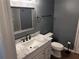 Cozy bathroom showcases dark gray walls, a vanity, and a toilet at 617 Aeolian Dr, New Smyrna Beach, FL 32168