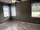 Comfortable bedroom featuring tile flooring, neutral walls, and bright windows with decorative valances at 617 Aeolian Dr, New Smyrna Beach, FL 32168