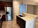 Modern kitchen island with stainless steel refrigerator and sink at 617 Aeolian Dr, New Smyrna Beach, FL 32168