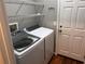 Laundry room with washer, dryer, and wire shelving for organization at 617 Aeolian Dr, New Smyrna Beach, FL 32168