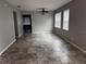 Spacious living room with tile floors, ceiling fan, and natural light from multiple windows at 617 Aeolian Dr, New Smyrna Beach, FL 32168