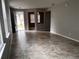 Inviting living room with tile flooring, neutral walls, and ample natural light from the entry at 617 Aeolian Dr, New Smyrna Beach, FL 32168