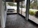 Screened patio featuring brick pavers and access to backyard with hot tub at 617 Aeolian Dr, New Smyrna Beach, FL 32168