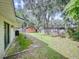 Backyard with patio, shed, and large oak trees at 628 10Th St, Daytona Beach, FL 32117