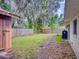 Backyard with shed, wooden fence, and grassy area at 628 10Th St, Daytona Beach, FL 32117