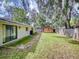 Spacious backyard with patio, shed, and large trees at 628 10Th St, Daytona Beach, FL 32117