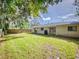 Large backyard with grassy area and wooden fence at 628 10Th St, Daytona Beach, FL 32117