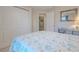 Bright bedroom features a closet, coastal decor, and an open doorway to another room at 682 Middlebury Loop, New Smyrna Beach, FL 32168