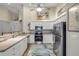 Modern kitchen with white cabinets, stainless steel appliances, and a decorative rug on wood flooring at 682 Middlebury Loop, New Smyrna Beach, FL 32168