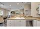 Open-concept kitchen featuring a breakfast bar and is adjacent to a dining area at 682 Middlebury Loop, New Smyrna Beach, FL 32168