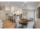 Bright open-concept kitchen and dining area with a breakfast bar and table for four at 682 Middlebury Loop, New Smyrna Beach, FL 32168