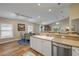 Bright kitchen featuring a stainless steel dishwasher, white cabinets, and an adjacent breakfast nook with seating for four at 682 Middlebury Loop, New Smyrna Beach, FL 32168