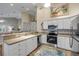 Bright kitchen with stainless steel appliances, white cabinetry and an open layout at 682 Middlebury Loop, New Smyrna Beach, FL 32168