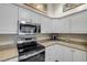 Modern kitchen with stainless steel appliances, ample cabinet space, and countertops for culinary creations at 682 Middlebury Loop, New Smyrna Beach, FL 32168