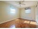 Bright bedroom featuring hardwood floors, ceiling fan and two windows providing ample natural light at 115 E Turgot Ave, Edgewater, FL 32132