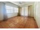 Bright sun room featuring tile floor, ceiling fan, large windows, and sliding glass doors to the exterior at 115 E Turgot Ave, Edgewater, FL 32132