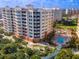Aerial view of the condo community showcasing building architecture and pool amenities at 253 Minorca Beach Way # 205, New Smyrna Beach, FL 32169