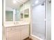 This bathroom is equipped with a glass shower and a mirror above the sink at 253 Minorca Beach Way # 205, New Smyrna Beach, FL 32169
