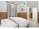 Stylishly decorated bedroom with bamboo trim, plush bed, and ensuite bathroom access at 253 Minorca Beach Way # 205, New Smyrna Beach, FL 32169