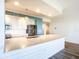 A bright kitchen features stainless appliances, white cabinets, and a large island at 253 Minorca Beach Way # 205, New Smyrna Beach, FL 32169