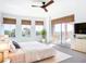 Spacious main bedroom with balcony access, multiple windows for ample natural light, and a ceiling fan at 253 Minorca Beach Way # 205, New Smyrna Beach, FL 32169