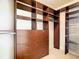 Walk-in closet with custom shelving, drawers, and ample storage for organization and convenience at 253 Minorca Beach Way # 205, New Smyrna Beach, FL 32169