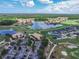 Stunning aerial view of a residential community featuring a golf course and lake at 3325 Pintello Ave, New Smyrna Beach, FL 32168