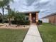 Inviting single-story home with a well-manicured lawn and pathway to the front door at 3325 Pintello Ave, New Smyrna Beach, FL 32168