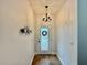 Well-lit foyer with tile flooring and a decorative wreath on the front door at 3325 Pintello Ave, New Smyrna Beach, FL 32168