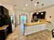Modern kitchen with stainless steel appliances, granite countertops, and tile flooring at 3325 Pintello Ave, New Smyrna Beach, FL 32168